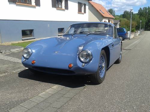 Early TVR Pictures - Page 73 - Classics - PistonHeads - The image features a vintage blue sports car parked on a city street. The car is the primary focus of the image, occupying a significant portion of the frame. It has a shiny exterior, indicative of frequent maintenance or recent purchase. The car is facing the left side of the image, leaving most of its front end visible. The setting appears to be a quiet urban residential area, as evidenced by the buildings, sidewalk, and street in the background.