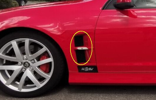 Pistonheads - The image features a red sports car, which appears to be a Corvette based on its design cues. The car is parked and is facing the camera. A distinctive feature of this vehicle is the black side mirror, which stands out against the vibrant red exterior of the car. Additionally, there's a noticeable sticker or decal placed on the side mirror, possibly indicating an event or affiliation with something specific, although the text is not legible in the image. The vehicle's license plate is also visible and suggests that it may be parked in a parking space designated for handicapped drivers, as indicated by the markings around the area where the car is parked.