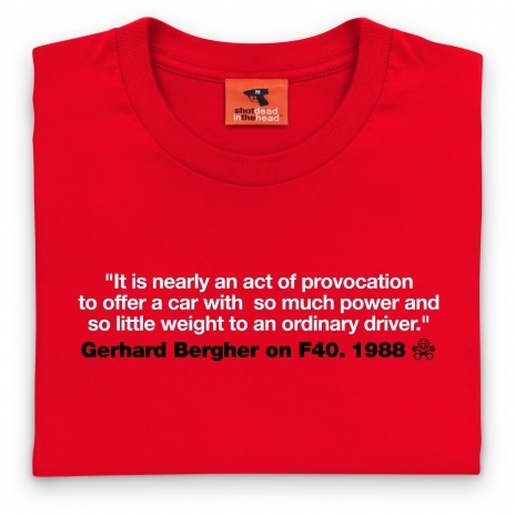 RE: Design a PH shirt, get paid.  - Page 1 - PH Shop - PistonHeads - The image shows a close-up of a red t-shirt against a neutral background. The shirt features a textual quote printed in white in the center front. Below the quote, there is a small, orange-bordered tag with the text "schott head" and a logo or emblem that appears to be a stylized "S" with a human-like face below it. At the bottom of the image, there is additional text in black that indicates the date of 1988. The style of the image is straightforward and product-focused, likely intended for retail or an online store.