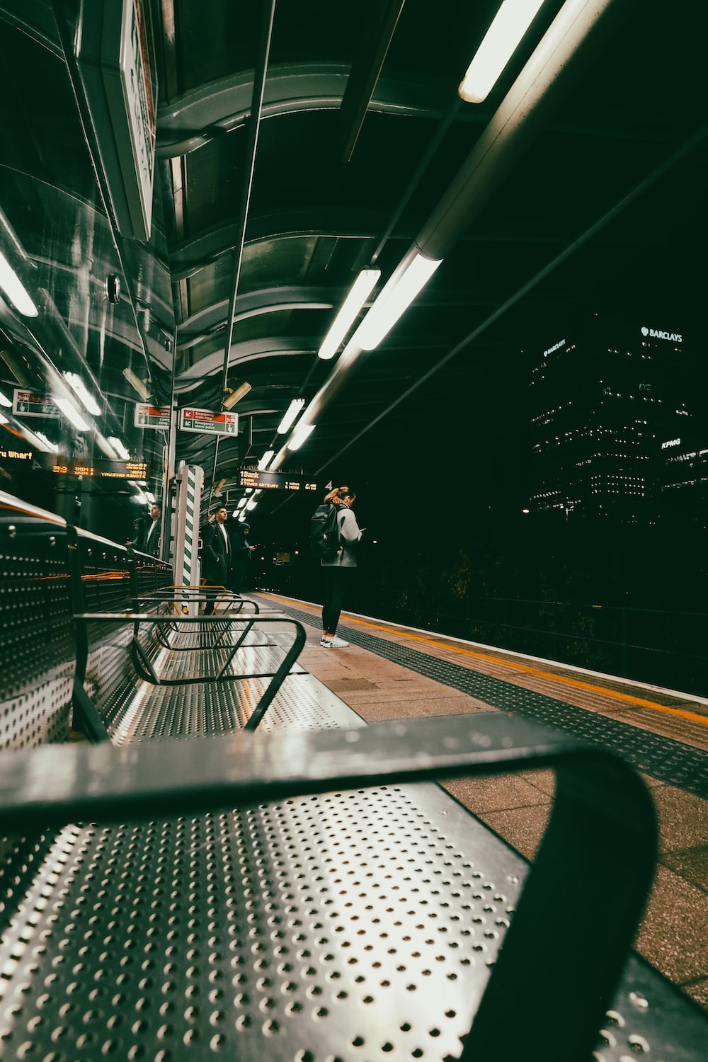 a train platform with a person standing on the platform