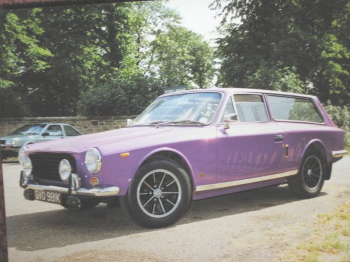 Estates Pistonheads Invader - In the image, there's a unique scene set in a park. A purple BMW, sleek and stylish, is parked on the park's asphalt path. The BMW, with its large black tires, stands out against the greenery. Just a few feet behind the BMW, another car is parked on the same path. The deep purple color of the BMW and its shiny finish reflect the sunlight, adding to its charming appeal. The picture captures a serene moment, where the stillness of the parked cars contrasts with the lively greenery that surrounds them.