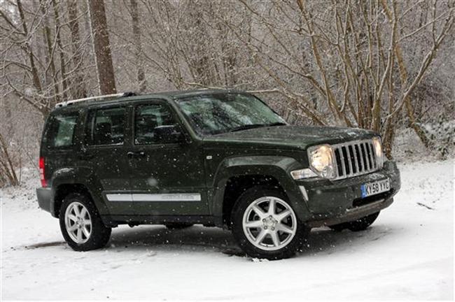 Nissan Murano - Page 1 - General Gassing - PistonHeads - The image shows a green suv parked on a snow-covered ground. It is a daytime scene with the vehicle positioned facing us. The tires appear to be winter-ready with a textured tread design. The surrounding environment is natural and wintry, featuring trees and shrubbery covered in snow, indicating that the photo was taken during harsh winter conditions.