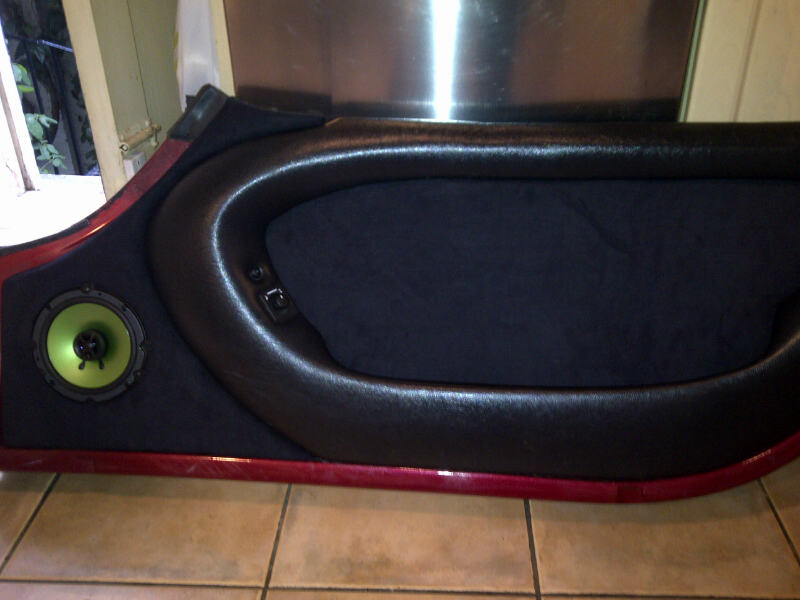 A tv sitting on top of a wooden dresser - Pistonheads - The image shows a cushioned piece of furniture, which appears to be a gaming chair or a similar type of ergonomic seating commonly used in gaming environments. The chair has a game-themed design with a red and black color scheme. The floor is tiled, and the chair is placed beside a wall. The chair itself is dark in color with a black cushion and a red frame.