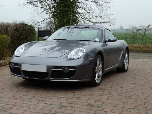 Dareen wanted pictures.... - Page 1 - East Anglia - PistonHeads - The image shows a modern, gray sports car parked on what appears to be a brick pavement. The car has a sleek design with distinctive LED headlights, large alloy wheels, and a prominent front grille. In the background, there are bare trees and a fence, suggesting a suburban or rural setting. The sky is overcast, implying that it might be a cloudy day. There is no visible text or branding within the image that can be identified.