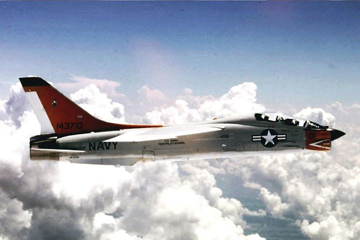 Post amazingly cool pictures of aircraft (Volume 2) - Page 221 - Boats, Planes & Trains - PistonHeads - The image captures a moment of a fighter jet, painted in red and gray, flying through a vast blue sky streaked with clouds. The jet has "U.S. Navy" written on the side, indicating its military purpose. The tail end of the jet features a U.S. Navy emblem, the "Anchor and Chain," symbolizing the strength and traditions of the U.S. Navy. The jet is moving from the left side of the frame towards the right, leaving behind a faint trail as it cuts through the air with precision and speed. The scene conveys a sense of power and freedom, characteristic of military aviation.