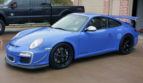 A blue car parked in front of a building - Pistonheads