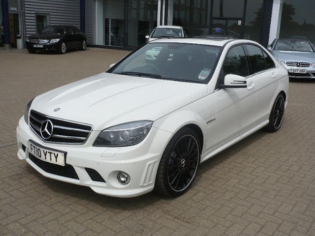 Driveway Stormtrooper Pistonheads - The image showcases a sleek white Mercedes-Benz, specifically the 2016 edition, parked on a brick road. The car's black rims and shiny details reflect off the surroundings. The day appears to be cloudy, providing a neutral background for the car. In the background, there are other cars and buildings, suggesting that the location might be a dealership or a showroom. The brick road on which the Mercedes is parked adds a touch of urban charm to the scene.