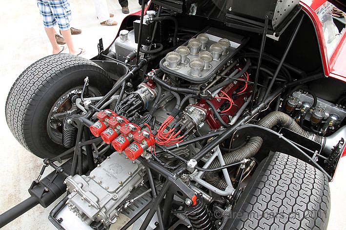 Guess the engine/car time... - Page 1 - General Gassing - PistonHeads - The image shows a close-up view of the underside of a vintage race car. The engine, which occupies a significant portion of the car, is visibly intricate with numerous cylinders, pipes, and mechanical components. The picture captures the complexity of the engine, showcasing the design and craftsmanship involved in automotive engineering. The car appears to be a single-seater, designed for high-speed performance. The car is not just a machine but also a testament to human ingenuity and passion for speed.