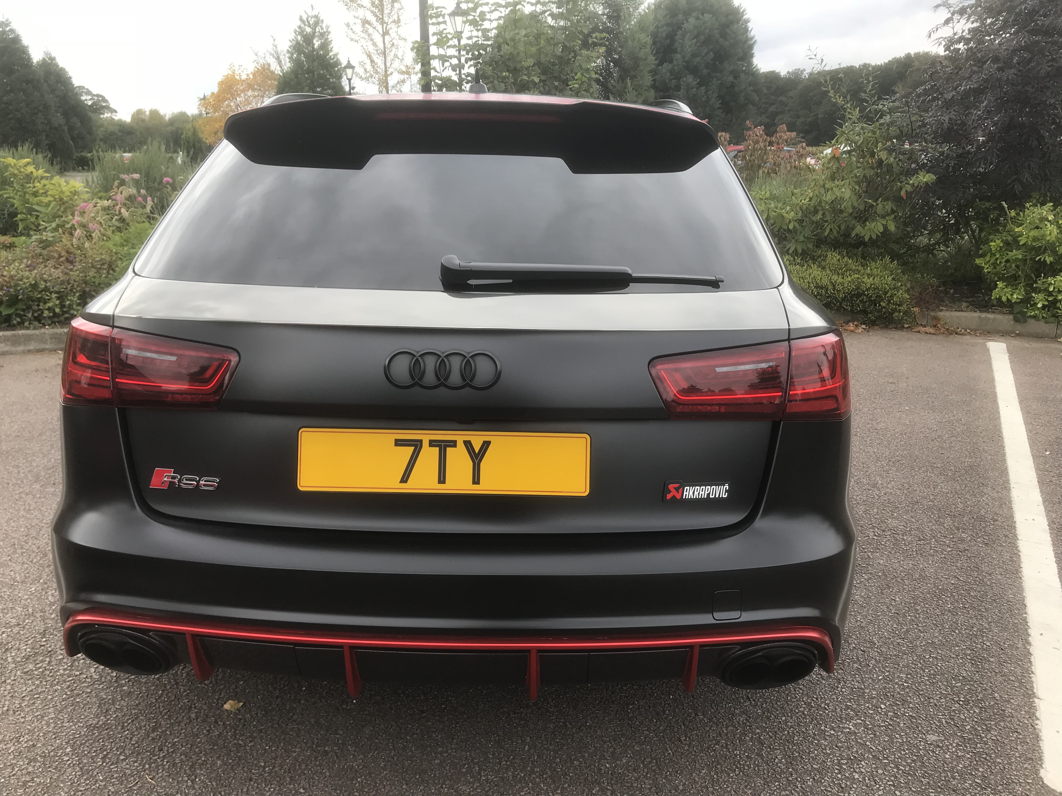 What C124PPY personalised plates have you seen recently? - Page 264 - General Gassing - PistonHeads - The image captures a sleek, black Audi A5 Sportback car, possibly a from an earlier year, given its design. The car's tail fin is prominently displayed in the top right corner of the image. It's parked in a spacious parking lot, adjacent to a paved area and lush greenery, indicating an outdoor setting. There is a license plate on the back of the car, bearing the letters "7TY". The Audi logo is visible, confirming the brand of the vehicle.