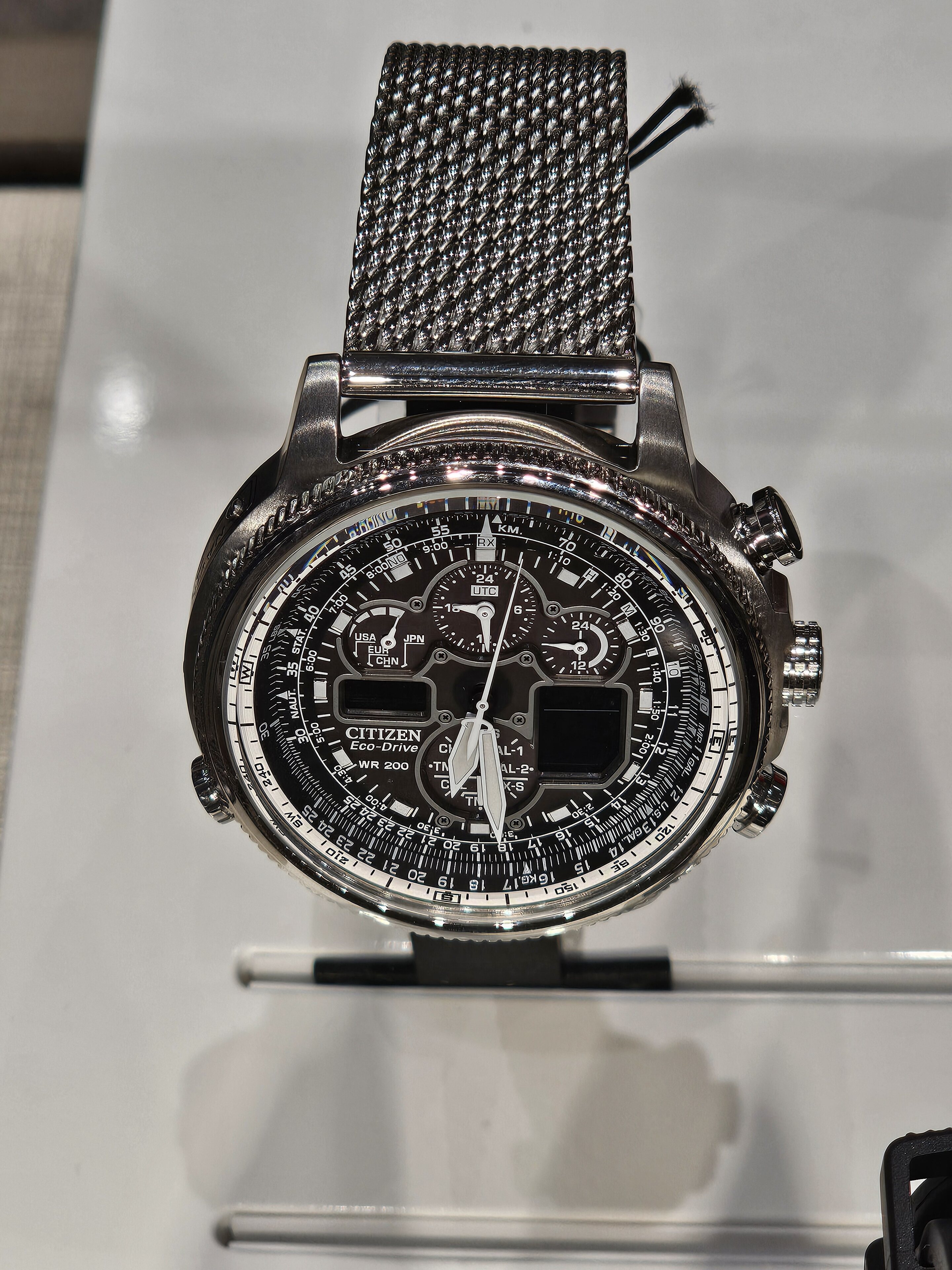 Pistonheads - The image showcases a wristwatch, prominently displayed on a stand against a white backdrop. It is an elegant piece featuring a black and gold color scheme, with the face of the watch clearly visible. A black strap wraps around the watch, adding to its sophistication. In the background, there's a display case that gives off a sense of luxury and exclusivity. The overall setting suggests that this might be part of an exhibition or display at a store specializing in luxury items.