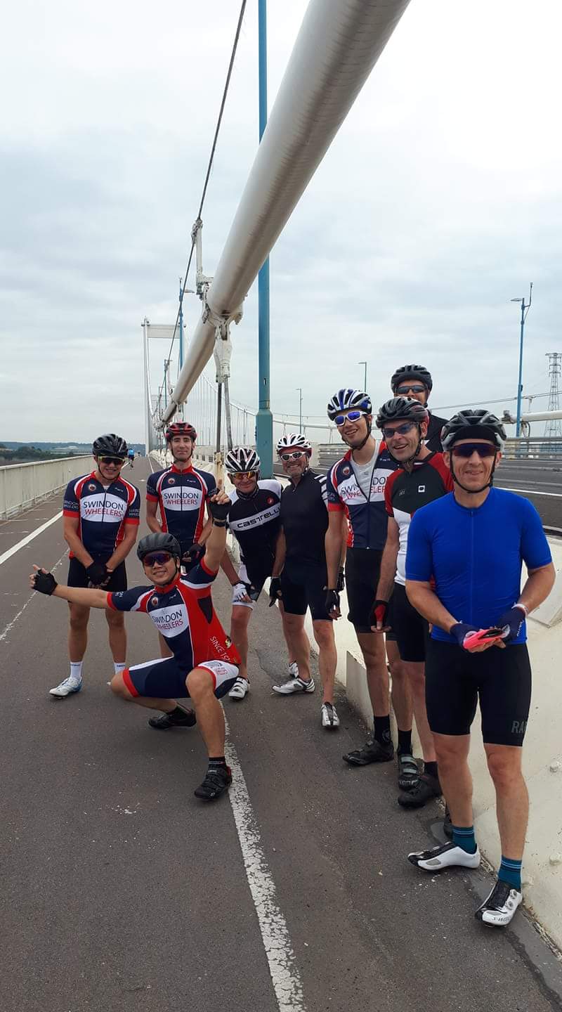 The "Photos From Today's Ride" thread... - Page 356 - Pedal Powered - PistonHeads - The image features a cycling team on a bridge, posing for a group photo. They are all in uniform, signifying they are part of a group or team. The uniforms are somewhat similar but identify each racer. The setting appears to be before or after a race, given their gear and presence near the bridge. They are standing close together, suggesting camaraderie and teamwork.