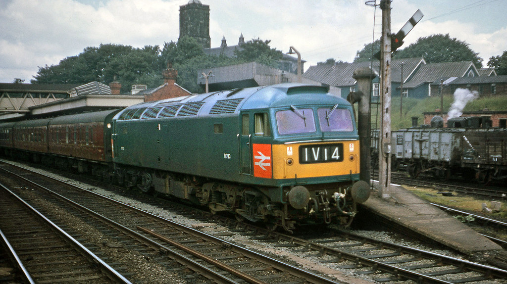 APT What we nearly had! - Page 5 - Boats, Planes & Trains - PistonHeads UK - The image features a vintage photograph of a steam locomotive on tracks, with a single train car visible. The train is adorned with the number 1V2 and sports a blue livery. In the background, there are multiple buildings including houses, a church, and a railway station. The sky above is partly cloudy, suggesting an outdoor setting. This image captures a moment in time when steam locomotives were prevalent in rail transportation.