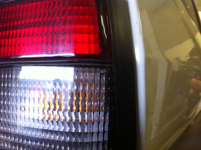 New Car Sneak Preview - Page 1 - East Anglia - PistonHeads - The image showcases a close-up view of a car bumper. The focus is on the tail light assembly, which is red in color. The tail light assembly is made of glass, placing a refractive lens that over filters. The background is out of focus, making the tail light assembly the prominent feature in the image. This type of image is commonly used for automotive purposes, such as advertising or detailing important features of a vehicle.