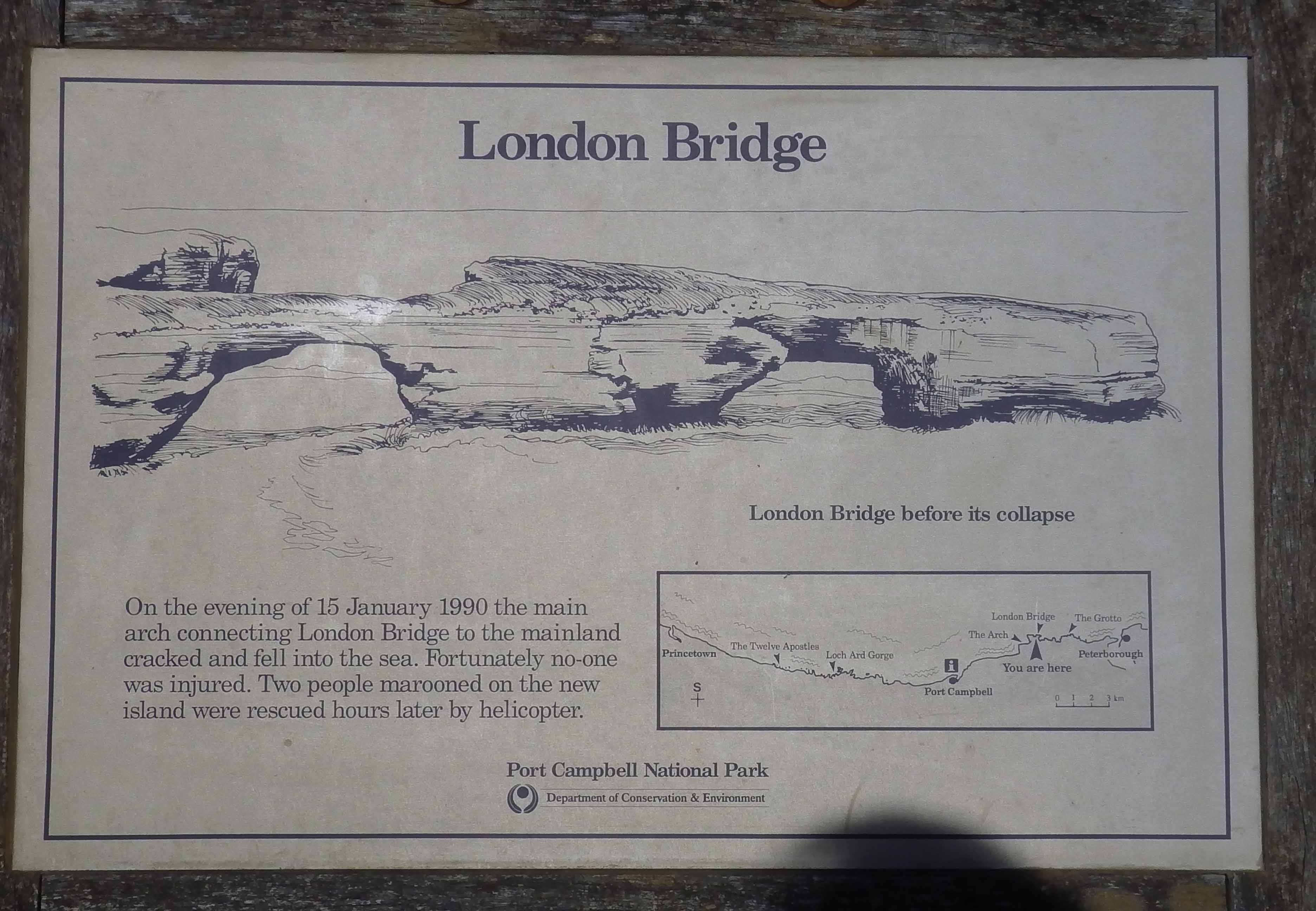 A sign that reads `` <UNK> '' on a building - Pistonheads - The image shows a historical information display with a relevant map on it. The text at the top reads "LONDON BRIDGE" in large, bold letters. Below this, there's an illustration of a broken bridge with a jagged, jagged cliff edge. To the right of the image, there's a rectangular map with labeled roads and some annotations regarding London Bridge's history. The timeline provided indicates the events leading up to the collapse of the old bridge in January 1989.

The bottom of the map contains some text, which includes the date and location of the event (Port Campbell National Park) and the official state bodies involved in managing heritage sites. The text also mentions the public inspection of the crime scene. The style of the image suggests it's an informative plaque at a visitors' site, possibly a historical park or museum. The shade cast on the display indicates it may be outdoors or near a window allowing natural light.