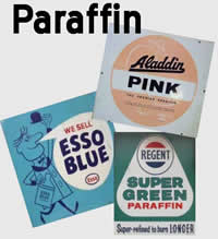 Evil smelling engine cleaner - Page 1 - Home Mechanics - PistonHeads - The image is a vibrant collage featuring six vintage signs, each showcasing a different brand of paraffin. The brands represented are Aladdin, Alden, Esso Blue, Essso Blue Plus, Super Green Paraffin, and Super Pink. Each sign is distinct, varying in colors from pastel blues to vibrant reds. The objects on these signs, ranging from smiling cartoons to billowing puffs of smoke, reflect the advertising strategies of the past. The relative positions of the signs suggest a comparison between the brands, with Super Green Paraffin and Super Pink prominently displayed, almost covering the entire image. The overall arrangement gives the impression of a nostalgic journey through the history of paraffin advertising.