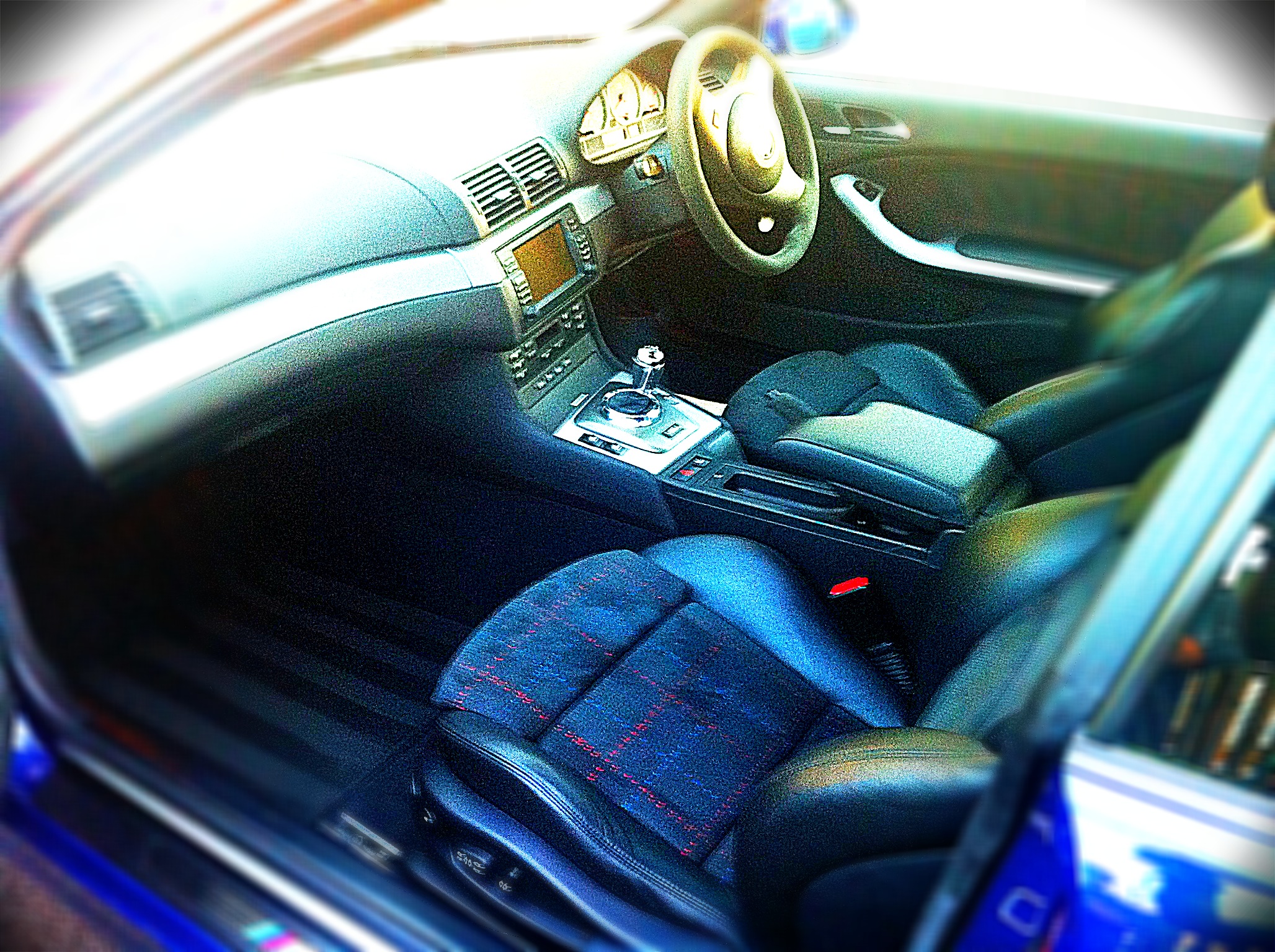 Pistonheads - The image captures the interior of a luxury car, highlighting the features of the center console and the mechanical intricacy of the side mirror. The dashboard, the driver's and front passenger's seats, and the black gear shift knob are clearly visible, displaying a combination of comfort and function. The coloration of the seats provides a striking contrast to the overall tone of the vehicle, indicating the high level of customization. The focus of the image is the owner's side of the vehicle, suggesting that the car is ready for a driver to take the wheel.