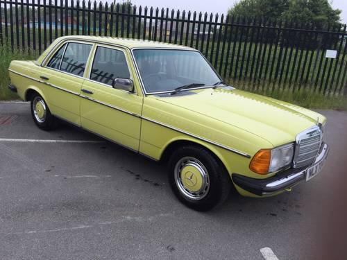 Classic (old, retro) cars for sale £0-5k - Page 225 - General Gassing - PistonHeads - The image depicts an older model Mercedes-Benz, painted in a distinctive shade of neon yellow. The vehicle is a two-door sedan with red and yellow interior, parked on a concrete surface. The Mercedes emblem is clearly visible on the front of the car. The surrounding area includes a chain-link fence and a partially visible building, suggesting the setting might be a parking lot or similar outdoor environment.