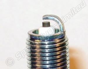 Spark plugs - Page 1 - Chimaera - PistonHeads - The image shows a close-up of a tall, thin cylindrical object with a metallic coating that reflects light, giving it a blue-green hue. At the top of the cylinder, there is a conical shape with a hole in its center, resembling the nozzle of a fire extinguisher. The object stands out against a plain background due to its reflective properties and the smooth texture of its metal exterior. The focus of the image is sharp on the surface of the cylinder, with the background being out of focus.