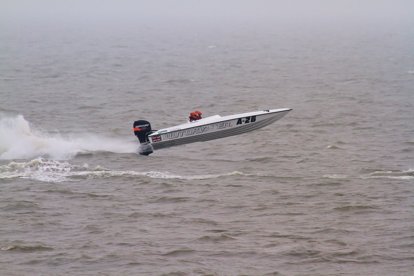 Show us your boat pics... - Page 10 - Boats, Planes & Trains - PistonHeads - The image depicts a thrilling moment on a river where a speedboat is leaping out of the water. The boat, which has the numbers "A22" on its side, is angled sideways in the air, creating a dynamic sense of motion. The sea is choppy, with white foam that indicates high waves, adding to the excitement of the scene. The boat is captured mid-air, soaring above the surface of the water. The image captures the thrill and speed associated with water sports.