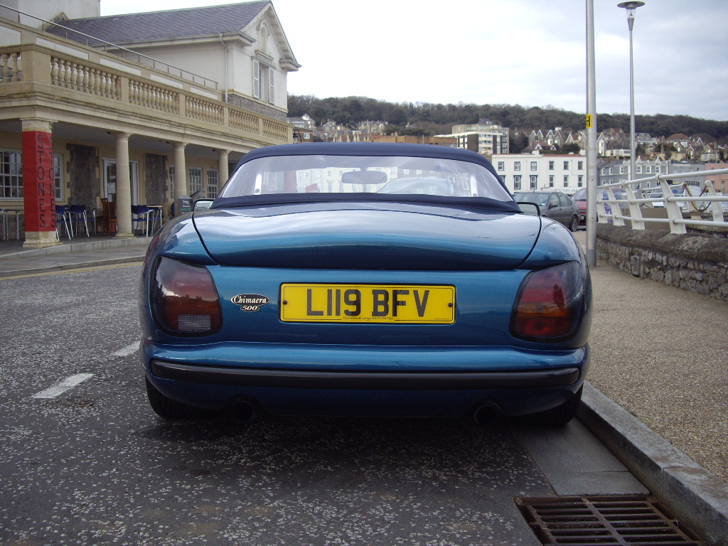 What did you do in the garage yesterday? - Page 213 - Chimaera - PistonHeads - In the image, a bright blue sports car is parked in front of a picturesque building with a balcony on the second floor. The car, adorned with a yellow license plate, has a roof down, suggesting a warm, possibly sunny day. The license plate is clearly visible and reads "LI19 BFVV". The building in the background has a classic architectural style, with columns lining the front, adding a touch of elegance to the scene. The contrast between the vibrant blue of the car and the soft, pastel colors of the building creates a pleasing visual effect.