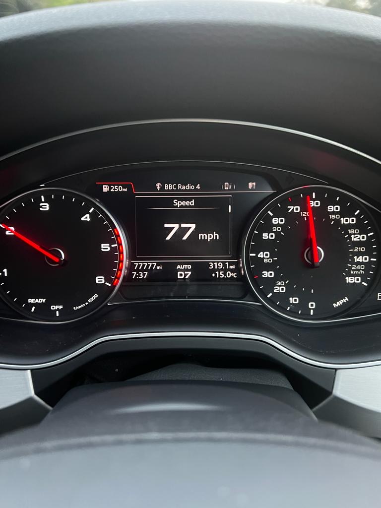 Pistonheads - The image shows a car's instrument panel. In the center of the dashboard, there is a digital display screen that indicates various pieces of information. On the left side of the screen, you can see the speedometer, which reads "70 mph," and below it, there is a fuel gauge at 5/8ths. The needle on the tachometer is pointing towards the red zone. To the right of this, there's a digital clock displaying the time as 12:54 pm. Additionally, there are indicators for the car's battery and oil levels. The dashboard also features the car's logo at the top center. The overall style of the image is a real-life photograph with an overlay that adds a digital element, likely to represent data on the vehicle's performance or status.