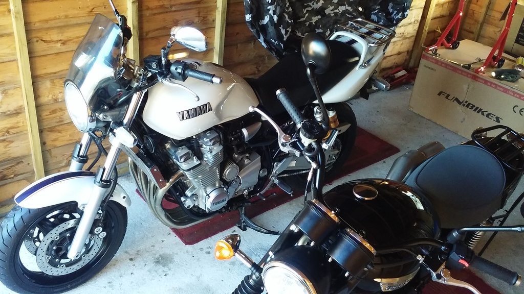 A motorcycle is parked in a garage with other motorcycles