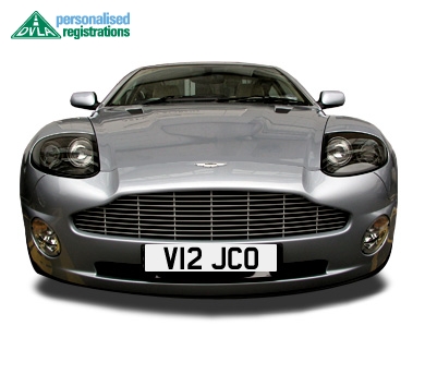 My new DB9 - Page 1 - Aston Martin - PistonHeads - The image displays a silver luxury sedan. The vehicle has a sleek design with sharp headlights. The car is fitted with a license plate on the front bumper. The background is white, providing a clear contrast to the car. In the bottom left and right corners, there are texts that appear to be watermarks or logos, but due to the resolution and size, the specific content of the text is not clear.