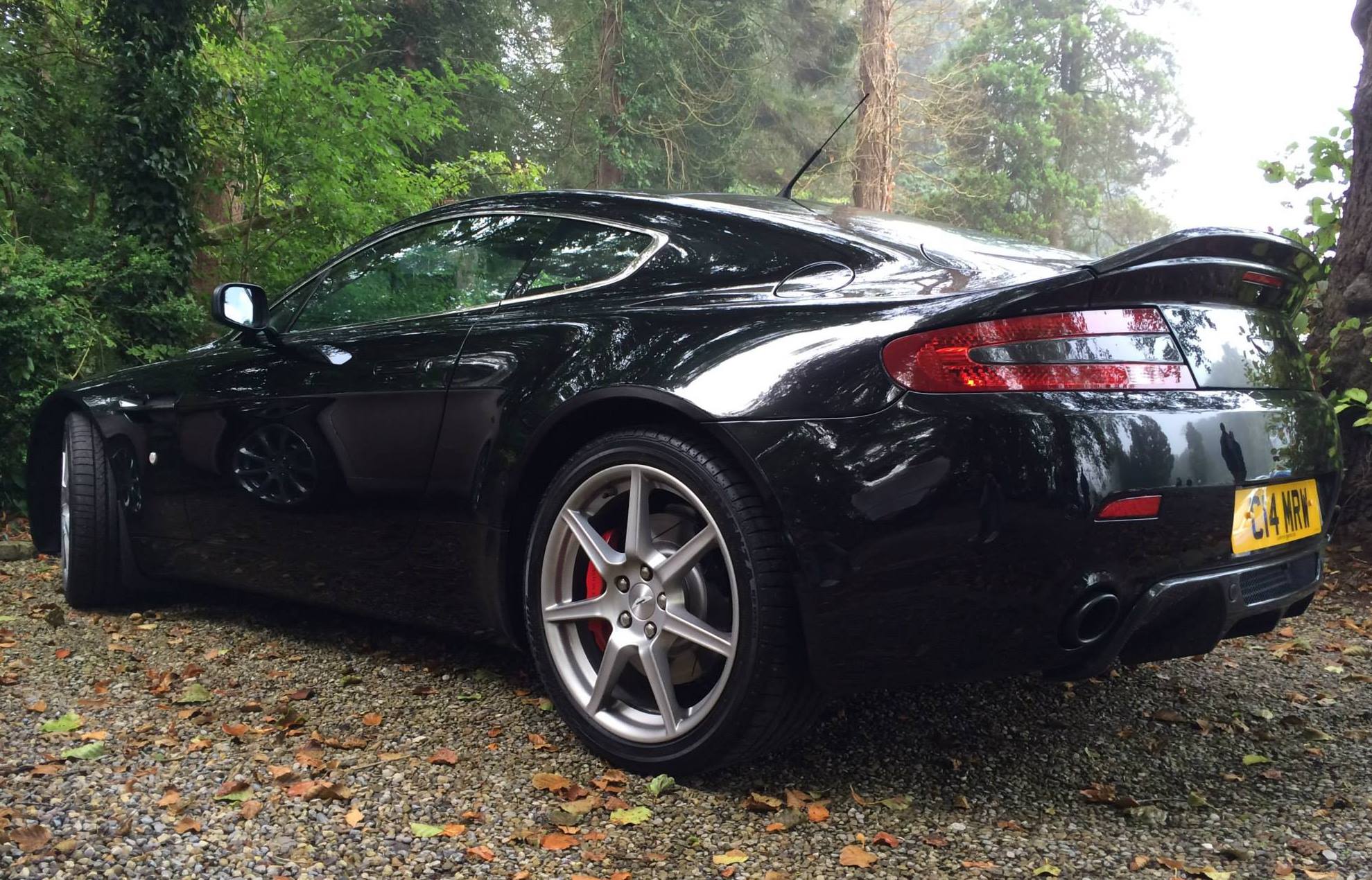 Show us ya cars... What you blasting around in 2015? - Page 3 - Yorkshire - PistonHeads - The image presents a spine-tingling visual of a black Bugatti Chiron, the fastest car in the world according to the manufacturer, parked amidst nature. The car is situated on a gravel road, adding to the rugged, off-road vibe. It has two doors, as is characteristic of sports cars, and its parking position suggests it's ready for swift departure. The surroundings, filled with trees and lush vegetation, provide a stark contrast to the sleek, high-performance vehicle. The abrupt barrier to the rest of the road contributes to a sense of tranquility and seclusion.