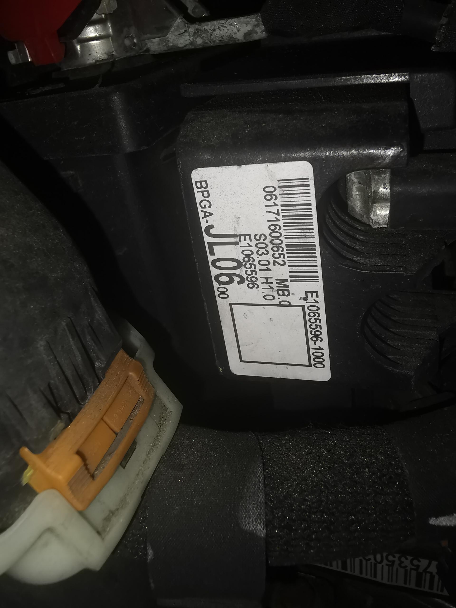 2017 Peugeot 3008 issues - Page 1 - French Bred - PistonHeads UK - The image shows a close-up of an engine, specifically focusing on the spark plug area. There is a white label with black text attached to the engine, and it appears that someone has attempted to remove the spark plug but not successfully. A pair of pliers is visible in the lower part of the image, indicating that this may be an ongoing repair or maintenance process. The engine seems to be from a vehicle, as suggested by the presence of components typically found in automotive engines.