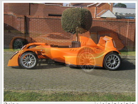 Caparo Stratton Pistonheads Motor - The image displays a vibrant scene featuring an orange, vintage-style car with a distinctive, exaggerated design, possibly designed for the street meets raceway world of Tgili environments. The car is positioned on a brick paving that contrasts with its sleek lines, suggesting a blend of modern and historic aesthetic elements. In the background, there is a red brick wall with a small tree growing in it, providing a touch of nature amidst the urban setting. Additionally, a white fence is visible behind the car, possibly indicating the edge of a property or park. The image has a watermark suggesting it might be from a stock photo website.