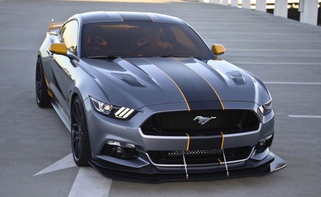 2015 Mustang - Page 1 - Australia - PistonHeads - This image captures a striking gray Mustang parked in a parking lot. The car is angled away from the camera, allowing us a view of its side profile. Its glossy finish and shiny black rims are the main features. Unique elements of the design include a yellow stripe running down the hood and a distinctive pattern on the side, suggesting a customization or racing modifications. The Mustang's sleek design and vibrant colors stand out against the concrete of the parking lot. Additionally, the perspective from which the photo is taken highlights the Mustang's powerful stance and impressive aerodynamics.