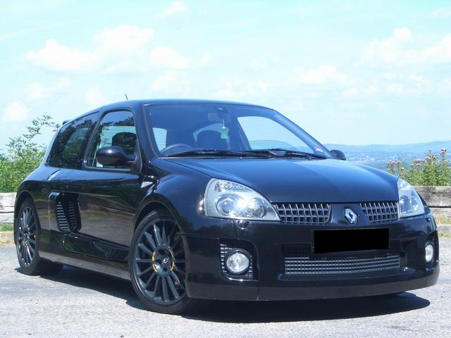 Looks like this will become a regular forum for me... - Page 1 - French Bred - PistonHeads - The image shows a black SUV stationed on a paved road. The vehicle is facing towards the left side of the frame, capturing the front portion of the car. It appears to be a Renault model, distinguished by its distinctive headlights and front grille. The car's design suggests a nineties era, and it's positioned against a backdrop of a blue sky with scattered clouds.