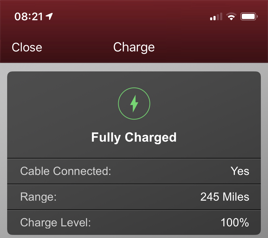 Just picked up my I Pace  - Page 11 - EV and Alternative Fuels - PistonHeads - The image shows a smartphone screen displaying an application with information about the device's battery status. The battery is fully charged, as indicated by the icon and the text "FULLY CHARGED" next to the battery level indicator. Below the battery status, there are two pieces of information: the cable type, "USB," and the range, "235 Miles." A charging percentage of 100% is also shown below these details. The screen also displays a message confirming that the device has been charged to its full capacity. The overall design suggests that this could be a screenshot from an app or interface used for monitoring battery status.