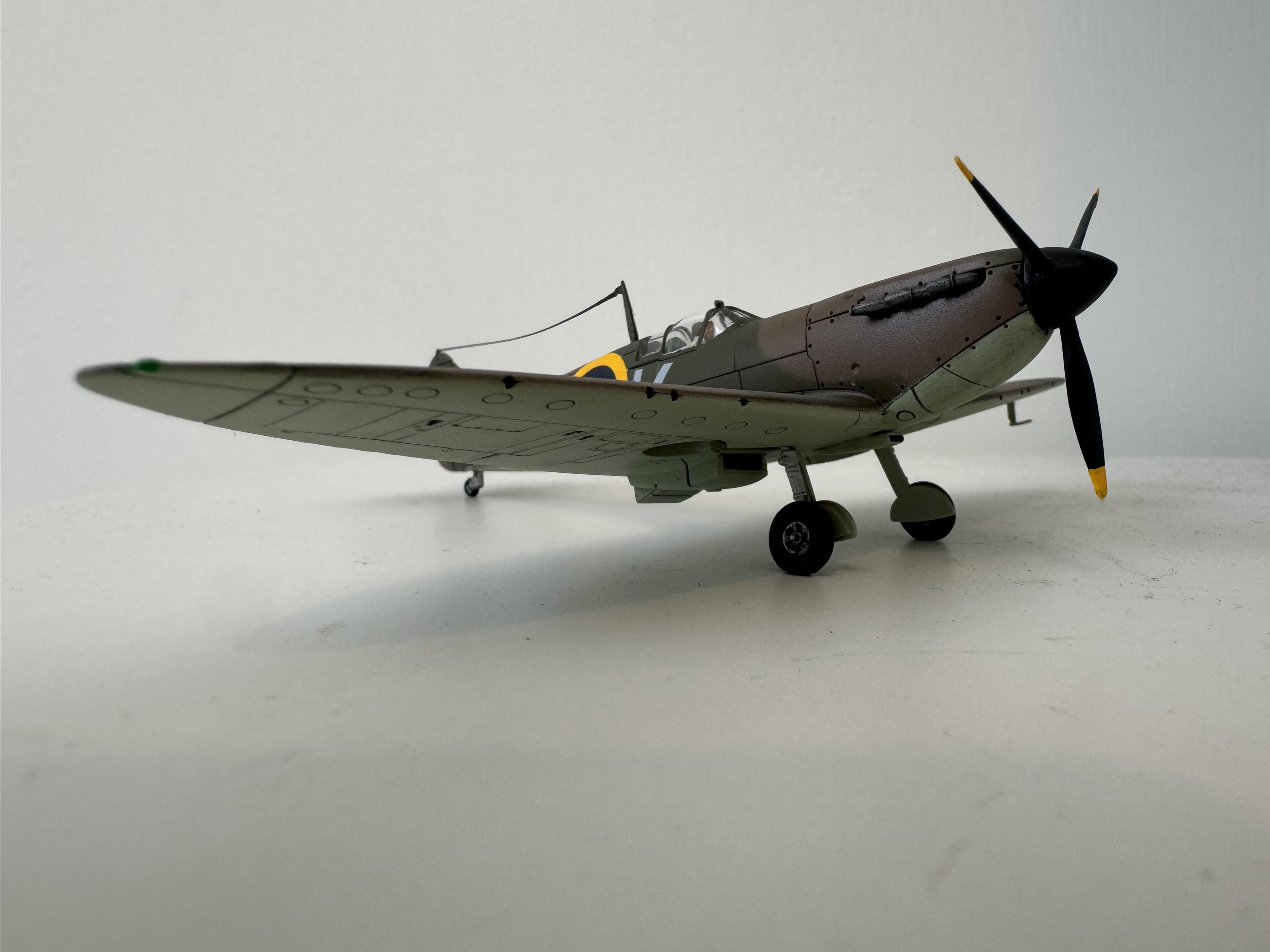 Pistonheads - The image shows a small-scale model of an old military aircraft. It's positioned on a flat surface and appears to be made of metal, as suggested by the shiny surface of the aircraft. The plane is painted in a realistic camouflage pattern with shades of green and brown, which suggests it may represent a historical military aircraft from World War II or similar era. The model has fine detailing, such as visible engine parts and the fuselage structure, indicating it's likely intended for display by model enthusiasts.