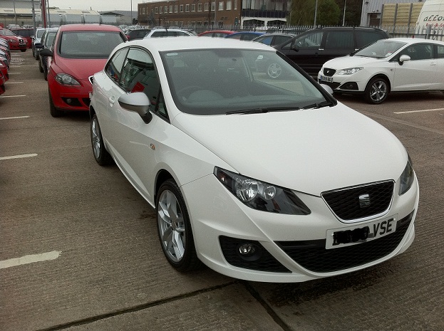 Tdi Pistonheads Seat Ibiza - The image features a white sedan parked in a parking lot. The car is made by SEAT and has a compact size. The vehicle is immaculately clean, indicating it's likely new or well-maintained. In the background, there are other cars parked, suggesting this is a public parking area. The overall setting seems to be an urban or suburban environment with a structured parking area.