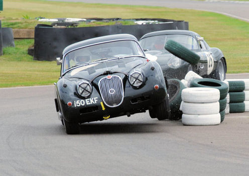 XKSS - Page 29 - Classic Cars and Yesterday's Heroes - PistonHeads - The image shows a dramatic scene on a race track where two classic cars are colliding. The cars, one with the number "10" visible on its side and the other bearing the text "BENTLE", appear to be in the midst of a high-speed accident. One car is turned sideways and is sliding off the road, while the other seems to have been forced into a spin by the impact. The vehicles are surrounded by several racing tires, indicating the action might have caused some debris or tire loss during the crash. This image captures a moment of intense competition and possible danger on the race track.