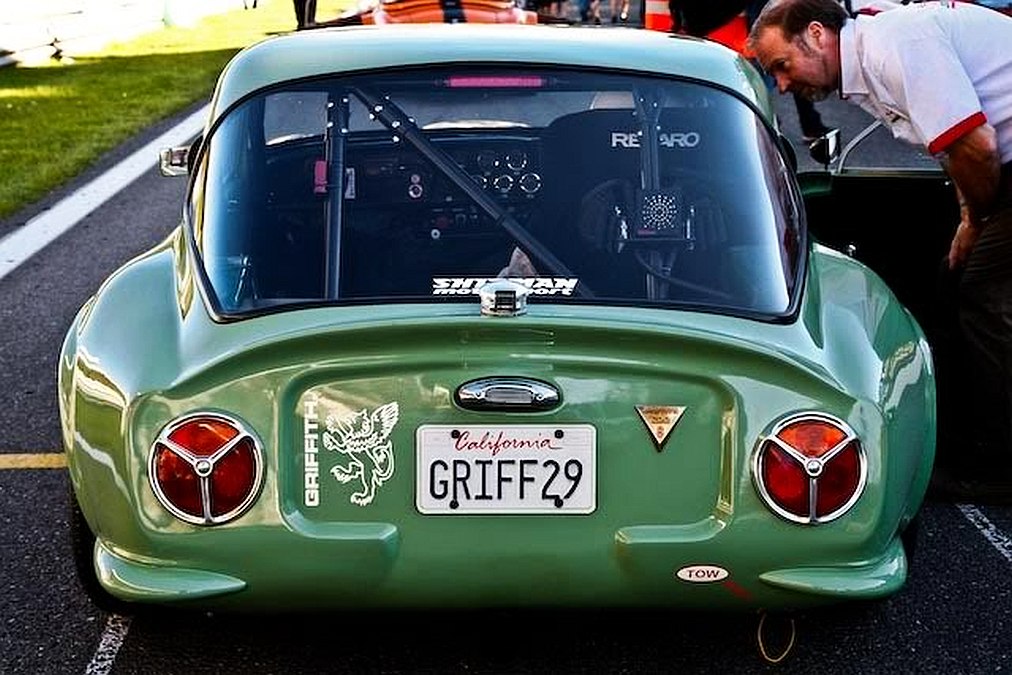 Early TVR Pictures - Page 26 - Classics - PistonHeads - This image captures a vintage racing car in detail. The car is green with a shiny finish, suggesting it might be on display or preparing for an event. The license plate is clearly visible and includes the words "Griff" and "18B29". The car is parked next to a man, who appears to be tending to it. The background and lighting suggest this scene is taking place during a car show or a similar event on a clear day.