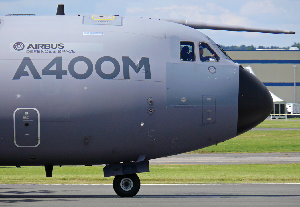 A small airplane sitting on top of an airport runway - Pistonheads - The image features a commercial passenger airplane on the tarmac of an airport. The airplane is predominantly in shades of gray, with the registration number A400 prominently displayed on the body of the aircraft. It appears to be an Airbus aircraft, distinguishable by the logo and branding on the fuselage. The plane is parked on the grass, which suggests it could be in a stationary phase possibly before or after a flight. The sky is partly cloudy, providing a clear view of the airplane and the runway in the background.