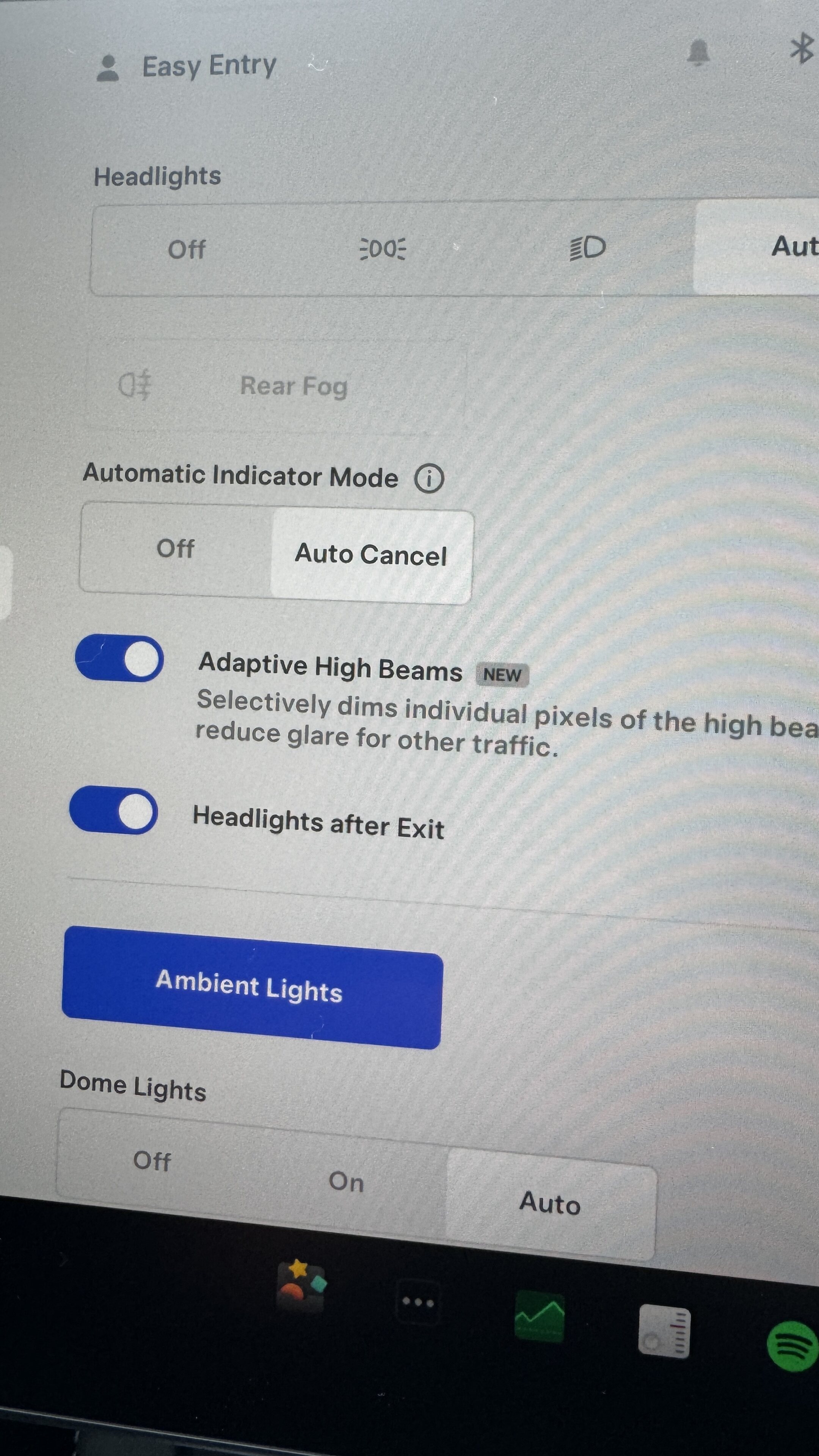 Pistonheads - The image shows a computer screen with a user interface that seems to be an automatic camera setting tool. At the top, there is a header that reads "Headlights." On the right side of the screen, there's an automatic mode option and a cancel button. There are two sliders below the headlight option: one for "Adaptive High Beams" and another for "Auto Adaptive Lights." The bottom part of the screen displays a message that says "Headlights are on." Additionally, there is a toggle to turn off automatic lights, with text indicating that turning them off will reduce the vehicle's visibility at high altitudes. At the bottom, there's an option to adjust high beams and another for exit lights, with the latter having a button that says "Turn On." The interface seems to be designed for user convenience in managing vehicle headlights.