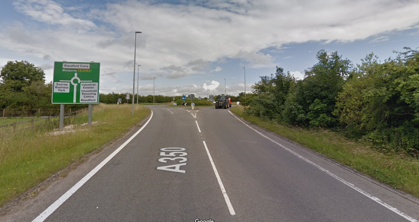 Drivers lurching to the right for no reason. - Page 1 - General Gassing - PistonHeads - The image presents a scene from a rural road. A street sign is visible in the foreground, indicating the name of the street and the direction of traffic flow. The sky above is overcast with clouds, casting a soft light on the surroundings. To the left of the photo, there's a field that stretches out into the distance, adding to the rural atmosphere. On the right side of the photo, a line of trees can be seen, further emphasizing the natural setting. The overall color palette is muted, with earth tones dominating the scene.