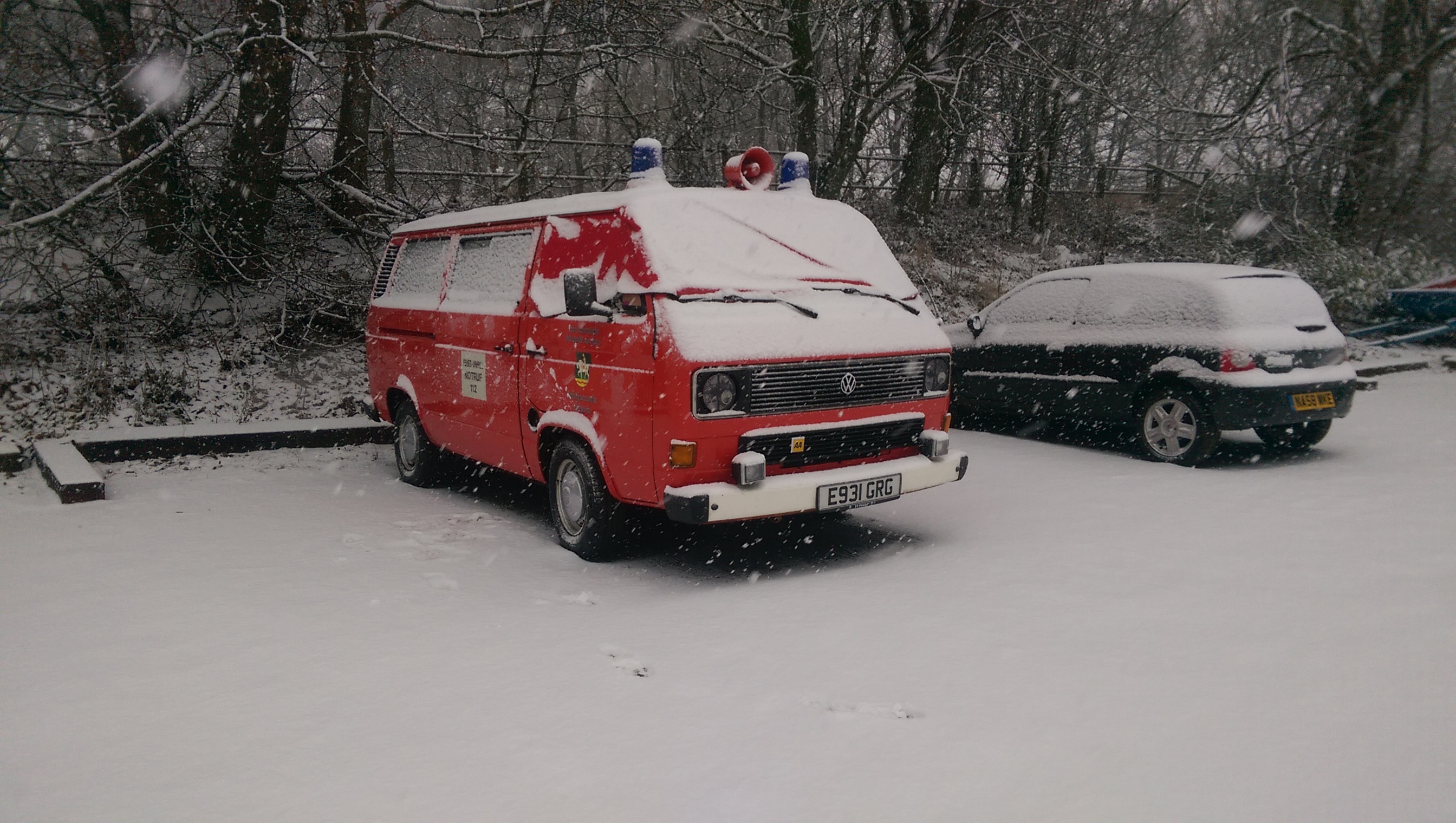 A red fire truck parked in the snow