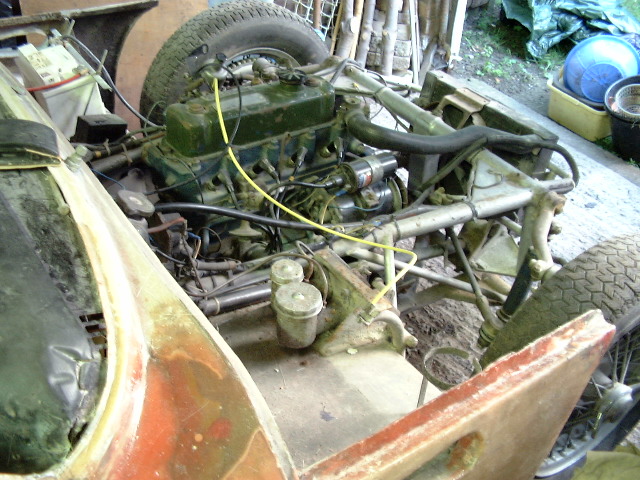 Early TVR Pictures - Page 72 - Classics - PistonHeads - The image features a vintage car's motor assembly that seems to have been removed. Dirty and rusted parts reveal the age and condition of the vehicle. A network of cables and wires can be observed, suggesting intricate settings or components. The motor assembly is in various states of dismantling, indicating a disassembled state. Overall, it appears to be a piece of history being restored or studied.