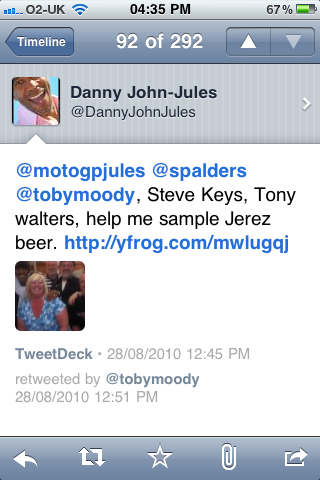 Pistonheads - The image is a screenshot of a tweet from a Twitter account named "Danny John-Jules". The tweet is directed to another account, "motogpjules", with the hashtag #SPALDERS. The content of the tweet mentions "Steve Keys, Tony walters, help me sample Jerez beer. http://www.frog.com/mwilugdj". The tweet also includes a photo of a person in a blue shirt. The screenshot shows the Twitter interface with time stamps at the top and other interaction icons.