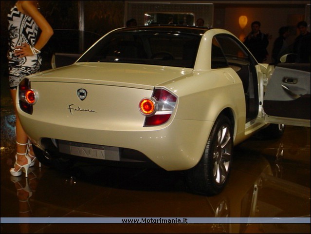 Quizanyone Pistonheads - This image features a beige two-door sports car with a glossy finish, presented in a showroom setting. A person is standing next to the car, providing a sense of scale, and the car's modest opening is at the door, perhaps to allow viewers to sit and admire the interior. The car has the Volvo logo, suggesting the manufacturer. The showroom reflects a modern interior design, with a slick floor and sophisticated lighting.