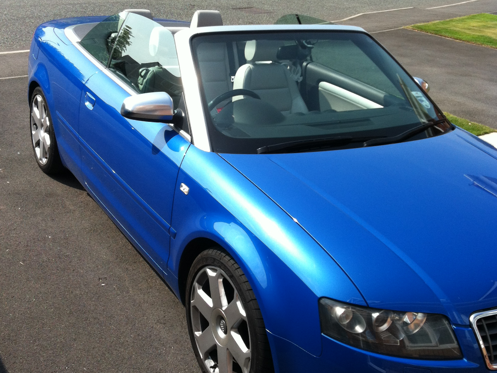 Audi RS / S / R8 picture thread! - Page 4 - Audi, VW, Seat & Skoda - PistonHeads - The image shows a blue convertible car parked on a pavement. The car is a woman's beauty salon, evident by the Sunroof windscreen. The rear section of the car offers a glimpse of the car's trim. No people are visible in the image and the car is stationary.