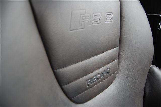 Tuscan Pistonheads Tvr - The image shows a close-up of a car's dashboard and back of a leather seat. The leather seat has a noticeable embossed logo that reads "RECARO." The dashboard also features a similar logo, indicating the design of the car's interior. The seat's material and texture give an impression of a luxury vehicle. The angle and focus of the image emphasize the details and craftsmanship of the vehicle's interior.