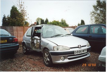 Show us your crash pics!! - Page 248 - General Gassing - PistonHeads - The image shows a gray car parked next to a metal fence, with an open passenger door. The car appears to be older, suggested by the nodular front design and license plate, which might indicate it's from the European Union. The scene happens during what looks like a cloudy day, as trees and bushes can be seen in the background. There's a timestamp in the bottom right corner of the image indicating it was taken on "29/10/00," which might be an error, however, as it's unlikely that October 29th exists.