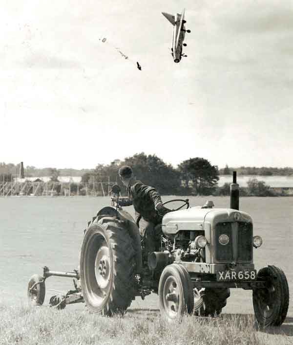 Spot the obvious defect - Page 6 - The Lounge - PistonHeads - The black and white image captures a moment from the past, featuring an old-fashioned tractor and a plumper. The tractor and its plumper are stationed in a field with a man at the helm. As the tractor begins to move, the plumper is captured flying into the air, creating a dynamic scene. The background reveals a clear sky and a few scattered clouds, adding depth to the image.