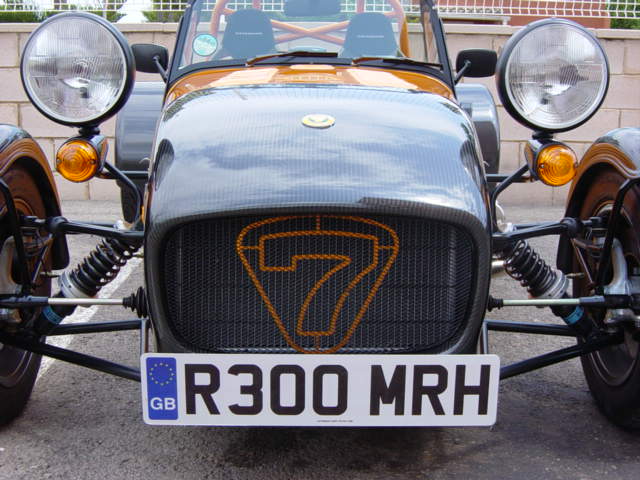 Sizes Headlight Pistonheads - This image features an old-fashioned vehicle, possibly a tractor or a specialized off-road vehicle, with a distinctive number seven on the front. The vehicle has a prominent grille with a globular design, which adds to its vintage appeal. The headlights are circular in shape, and there is a prominent Auto GMBH logo on the front. The vehicle is parked on a street with a brick building in the background.