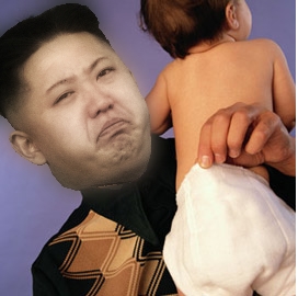 North Korea photoshop contest - Page 8 - The Lounge - PistonHeads - The image is a digitally altered photograph that superimposes the face of a man, possibly a politician based on the resemblance to a well-known figure, onto the body of a baby who is being held from behind. The man's face appears distressed, with a drastic facial expression, and he is wearing a patterned shirt. The baby's back is visible, with only its diaper being exposed. The overall tone of the image is surreal and likely intended for humorous effect. There is no visible text in the image.